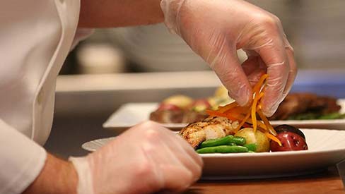 Food Handler preparing a plate of food